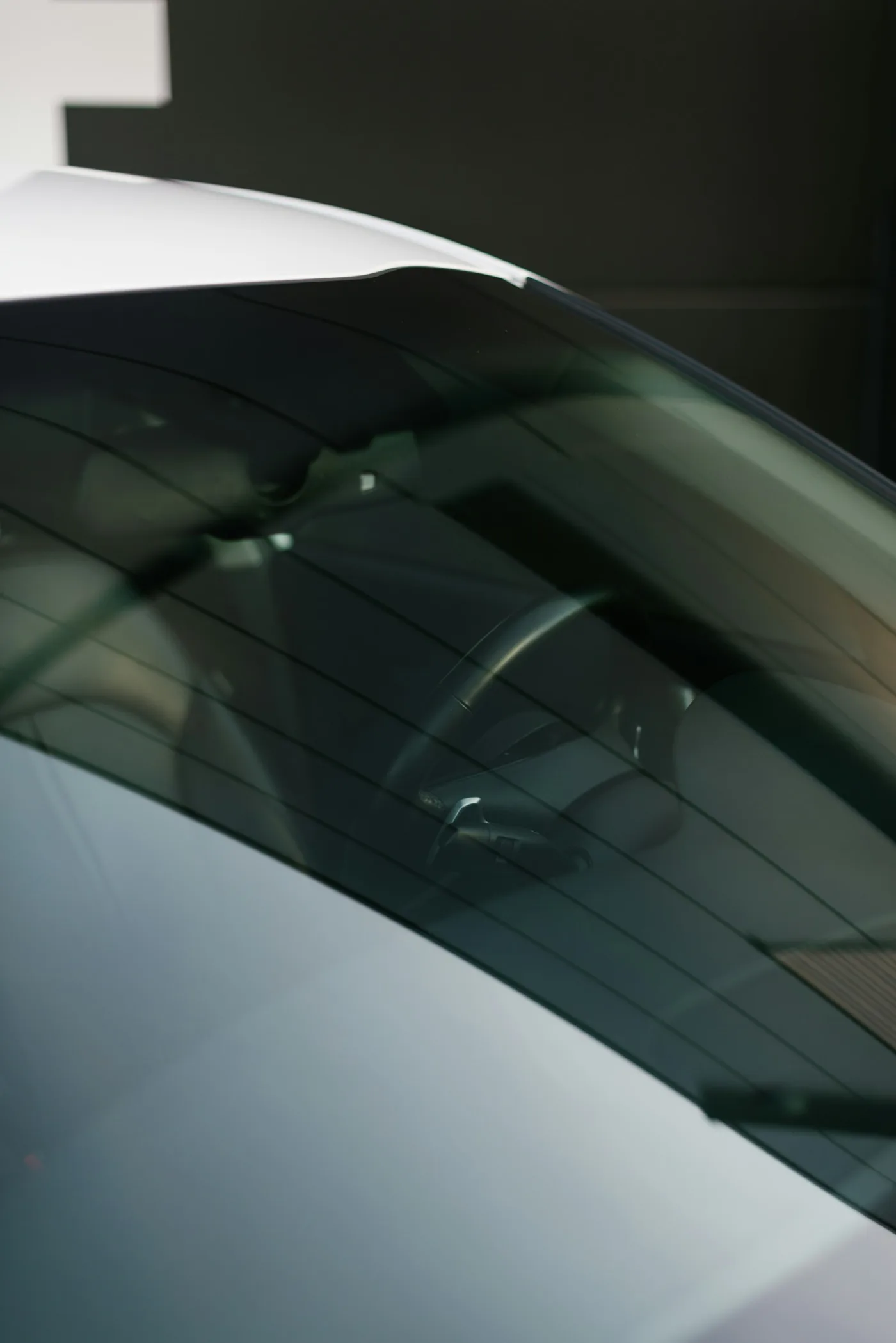 Dark automotive window tint on a white performance car