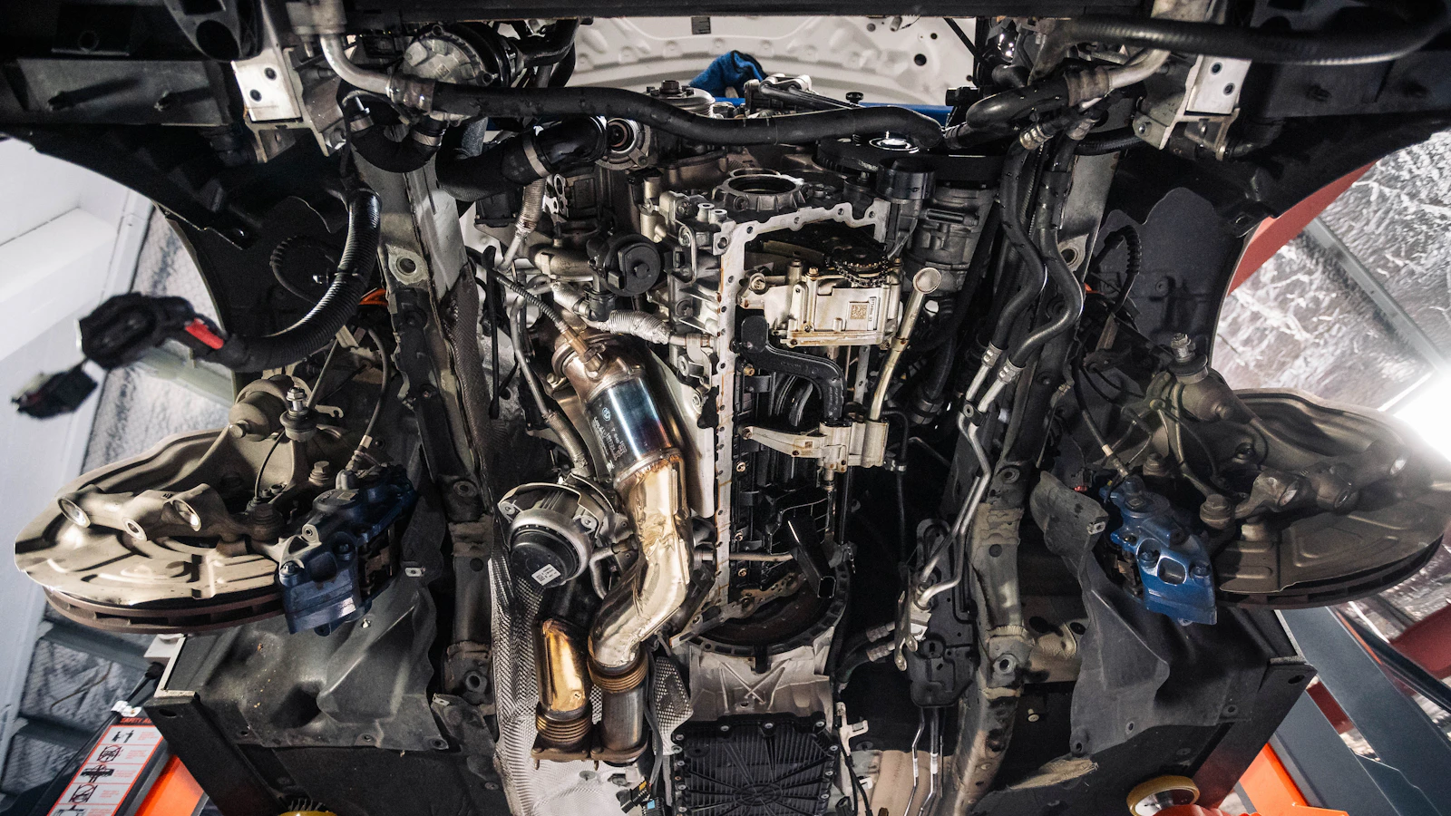 The exposed underside and mechanical components of a raised vehicle.