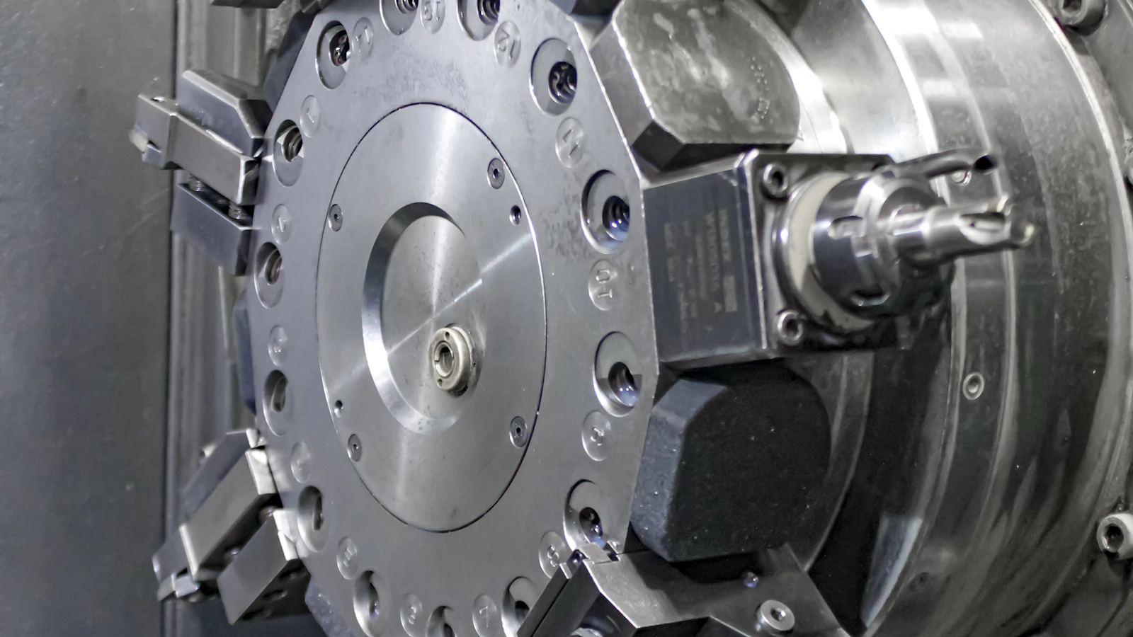 A close view of a circular metalworking tool assembly inside a machine.