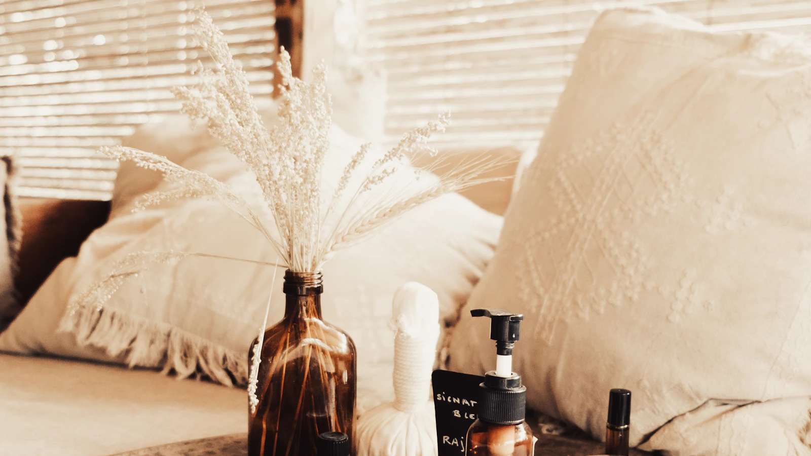Product bottles and a small vase displayed on a table.