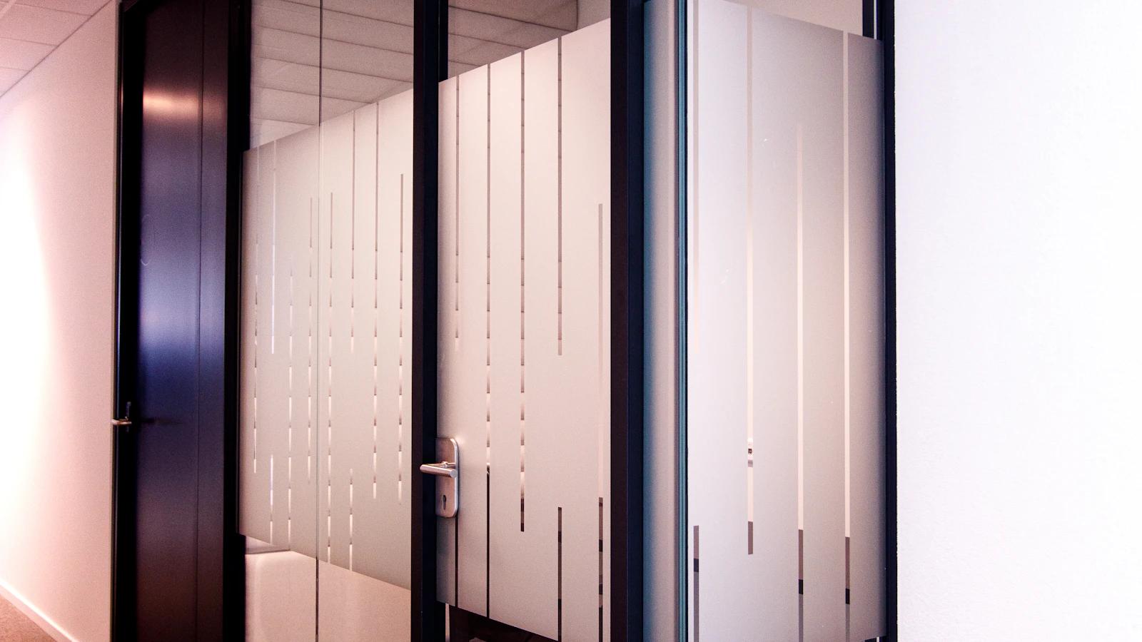 Interior glass doors with a vertical patterned finish.