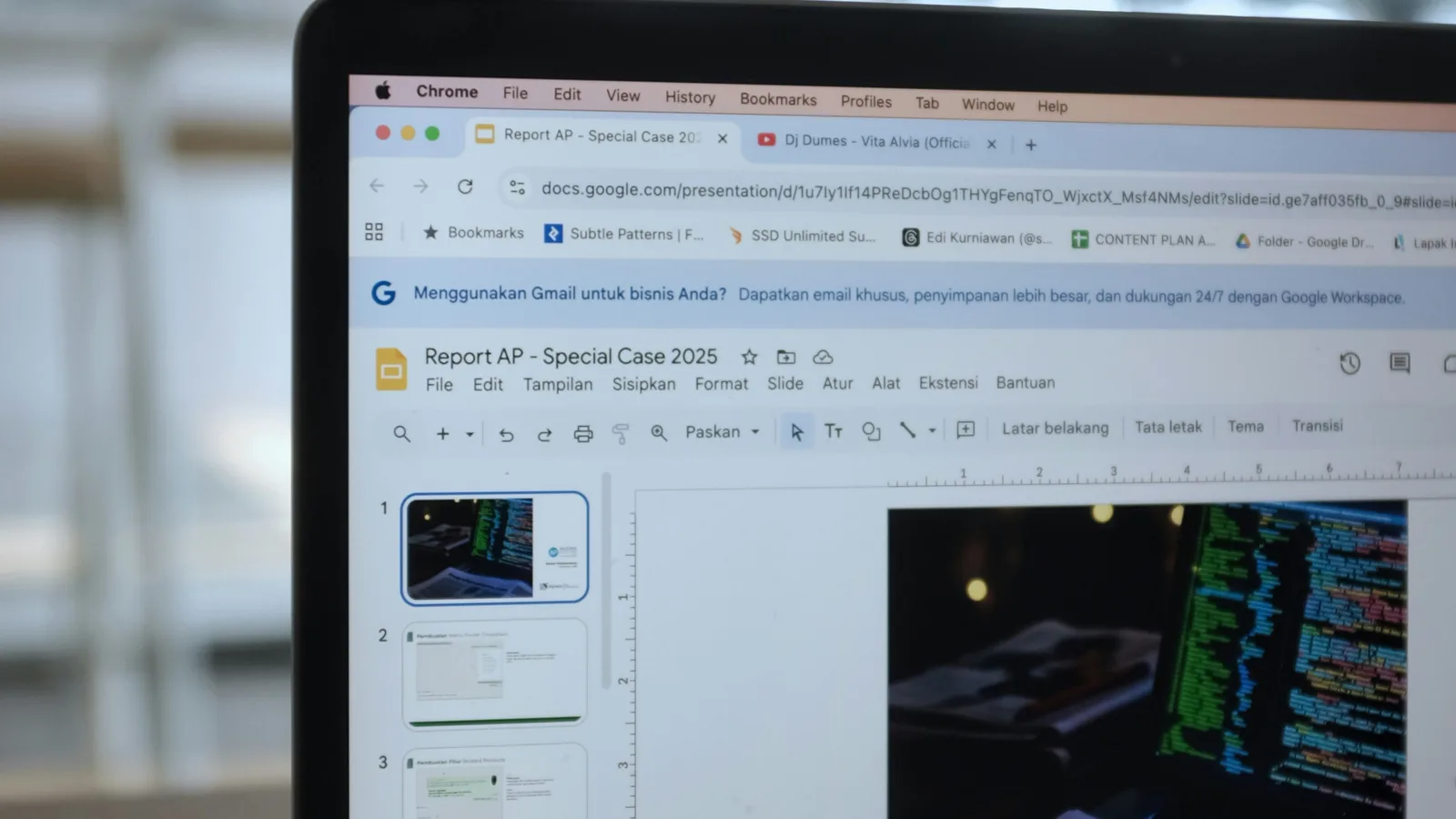 Laptop displaying a presentation with code on screen.