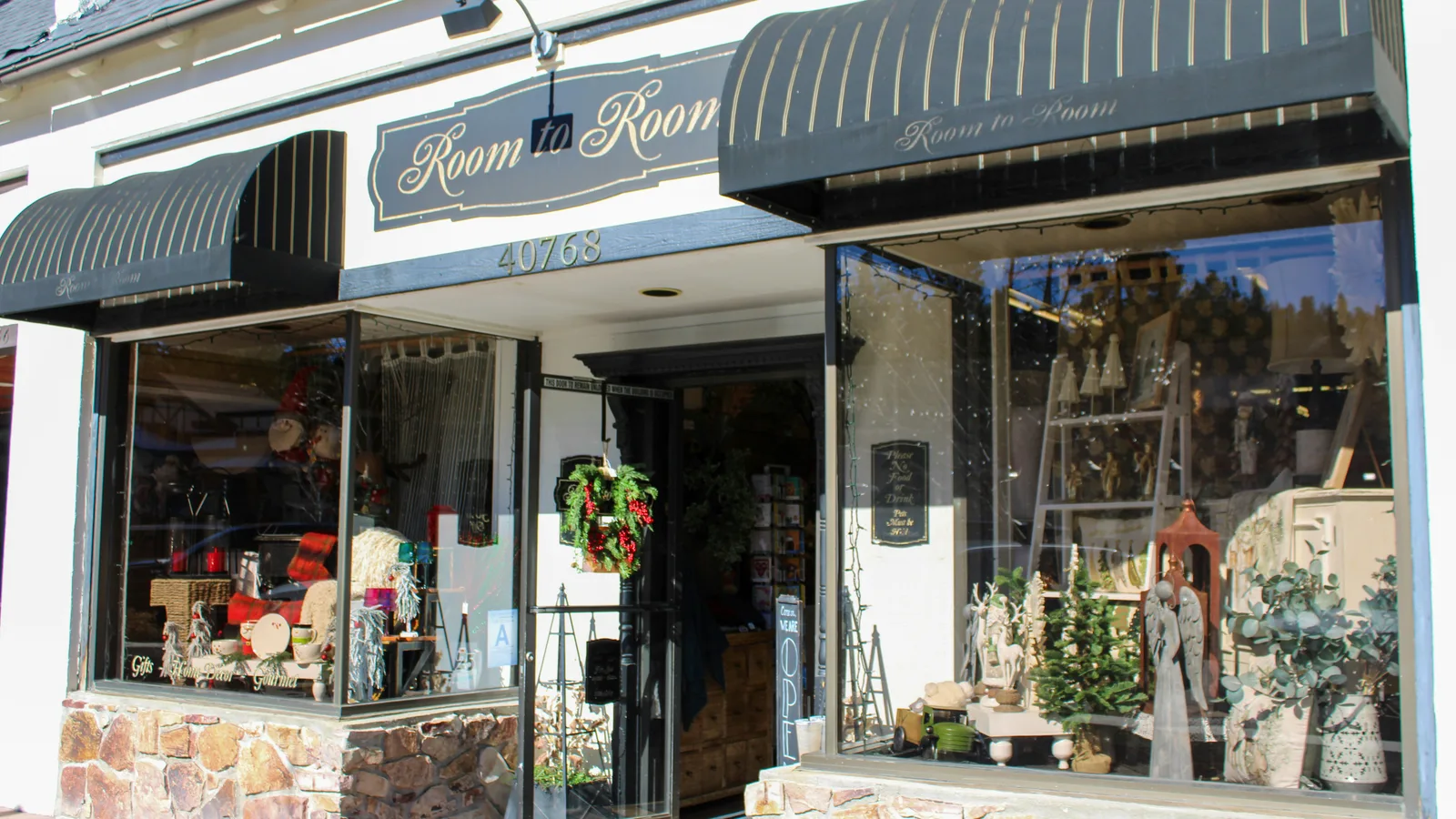 Shop entrance with striped awnings and window displays.