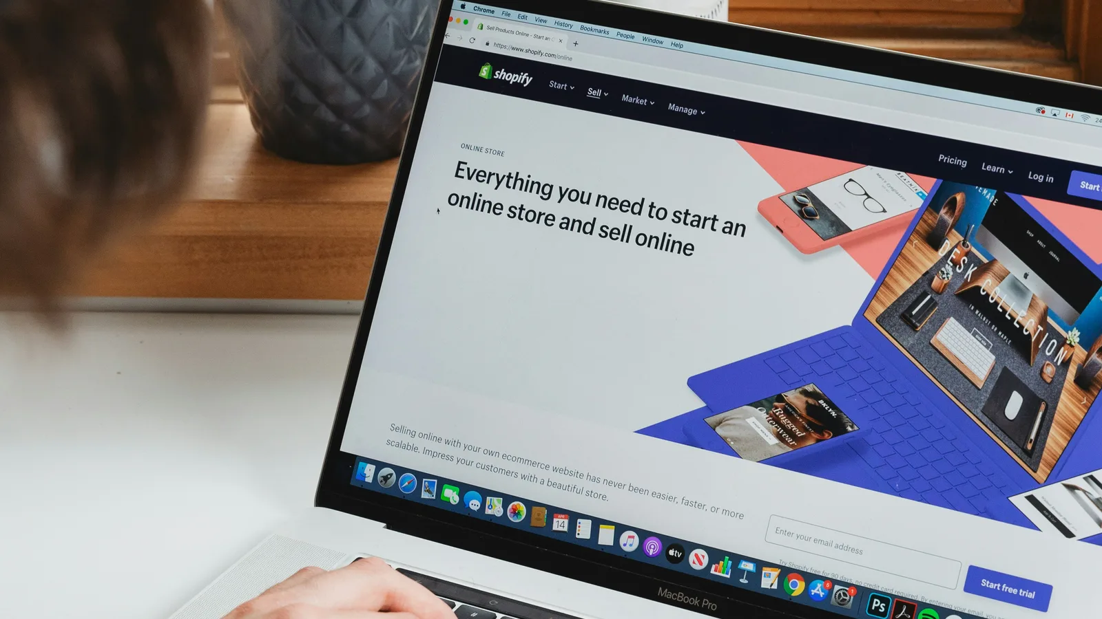Laptop displaying a website-building platform on a white desk.