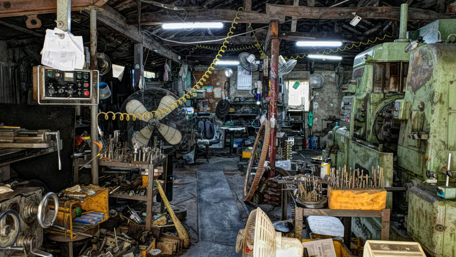 Industrial machine-shop interior with equipment and metalworking tools.