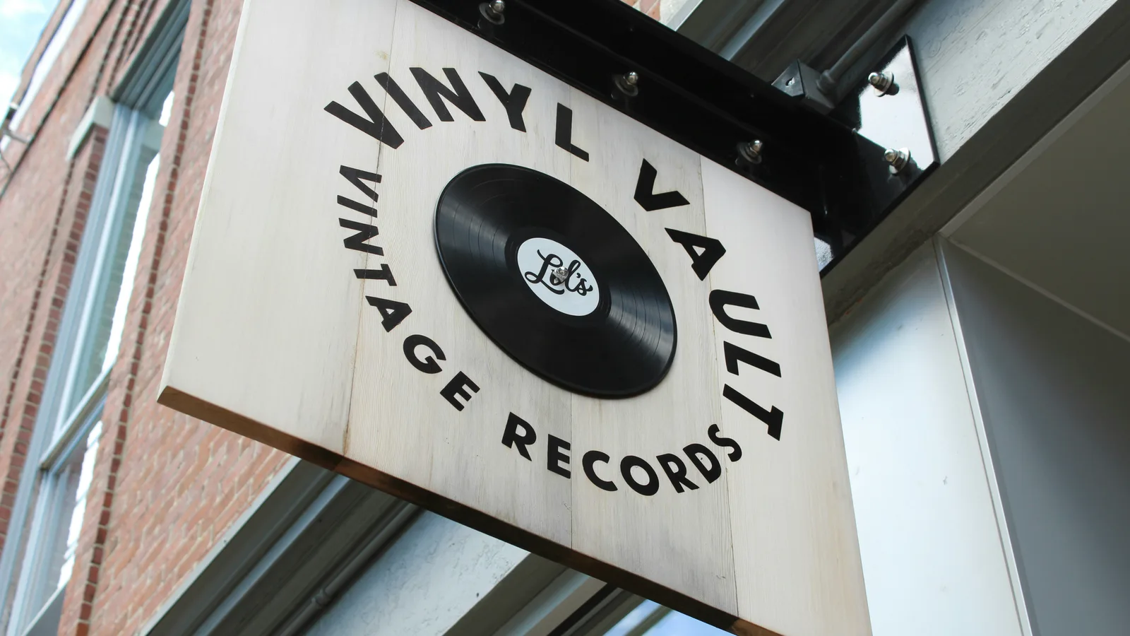 Vinyl-record shop sign mounted above a doorway.