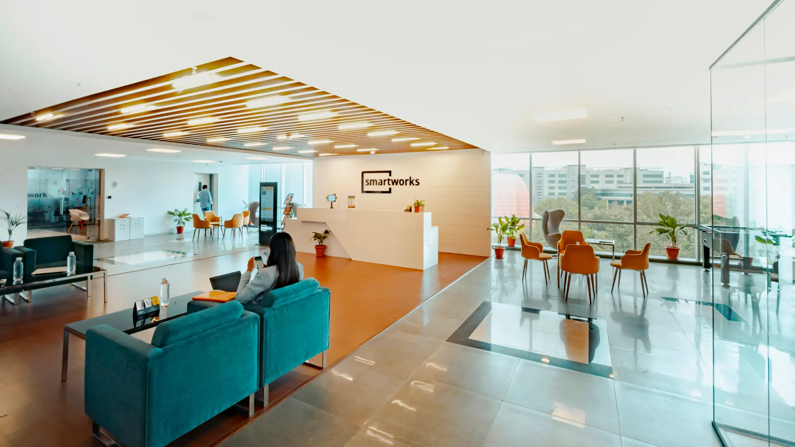 Bright reception area with blue seating and a front desk.