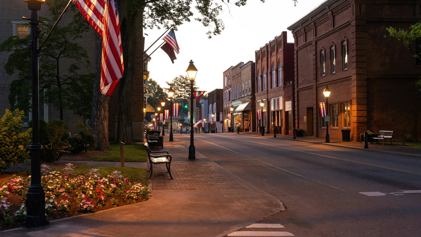 Storefronts along a small-town street at dusk.