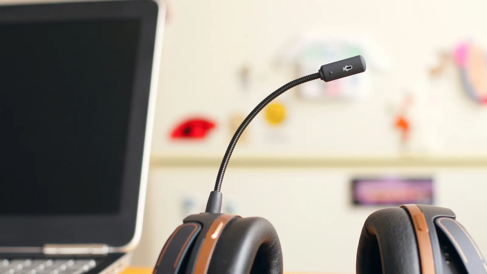 Black and brown headset near laptop computer.