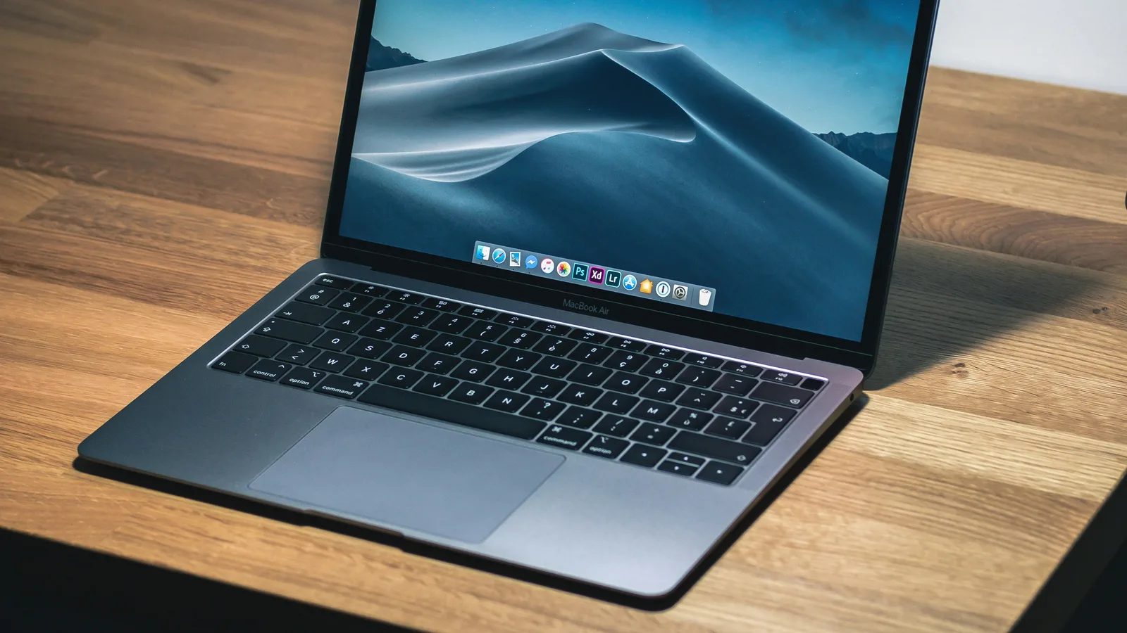 Open laptop on a wooden desk.