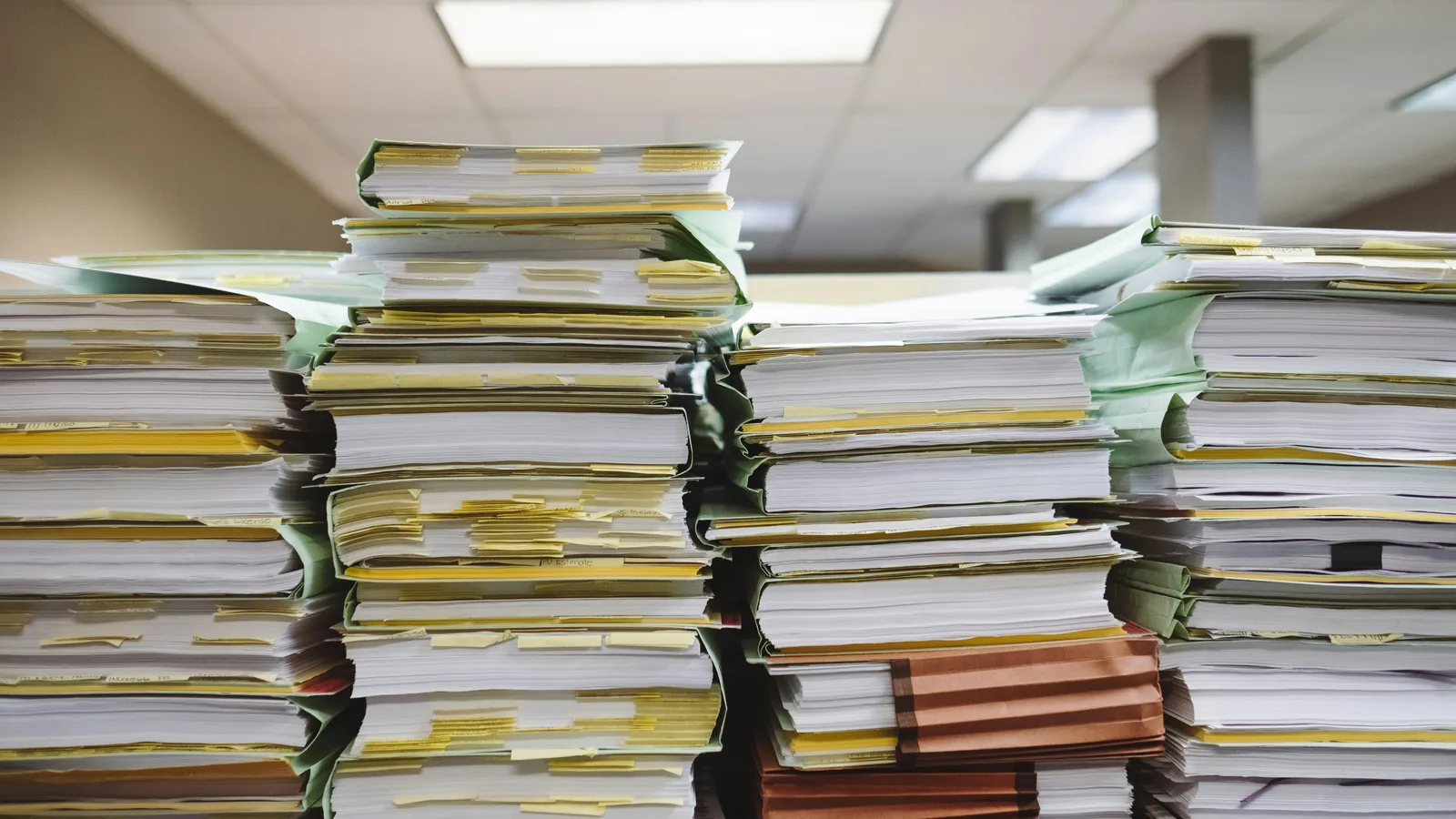 Stacks of paper documents and file folders.