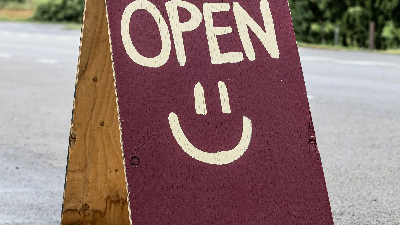A-frame sign with "open" and smiley face.