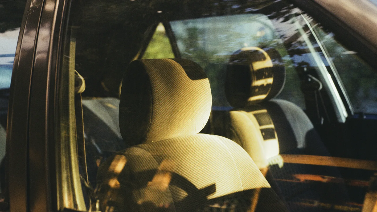 Interior of a car with light-colored seats.